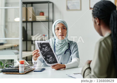 Showing sonogram to pregnant patient Showing sonogram to pregnant patient 116808629