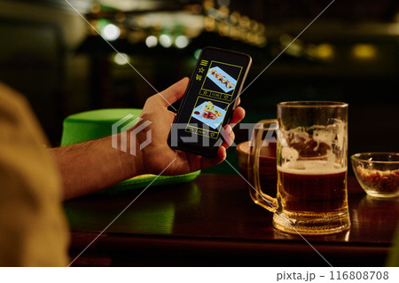 Man with phone ordering online food Man with phone ordering online food 116808708