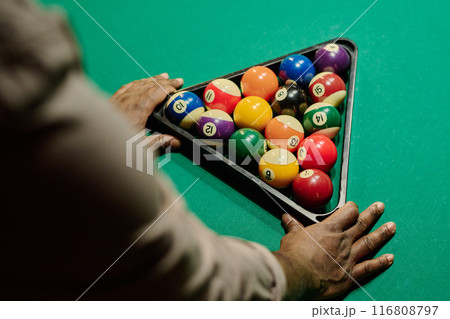 Man touching triangular rack with balls 116808797
