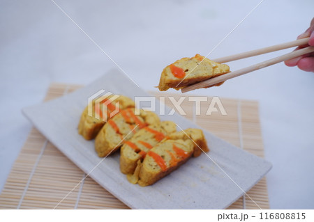 Slices of omelet on a plate  116808815