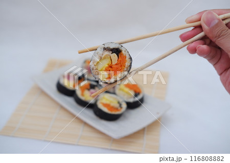 Sushi rolls on a plate on a white background. Japanese food Sushi rolls on a plate on a white background. Japanese food 116808882