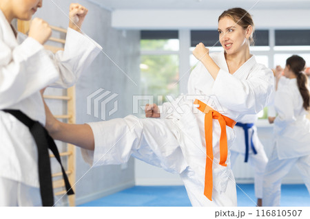 Two young women training karate techniques Two young women training karate techniques 116810507