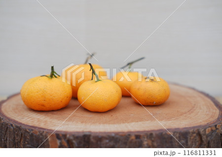 Fresh tangerines on a wooden background. Selective focus. 116811331