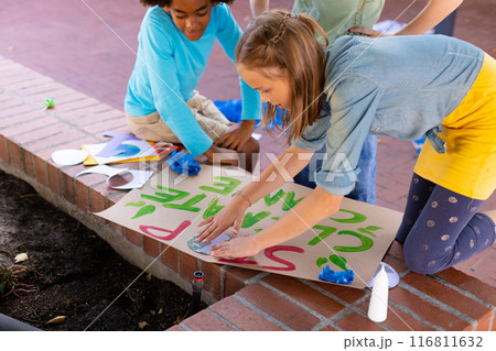Happy diverse schoolchildren making ecology posters during outdoor school art class Happy diverse schoolchildren making ecology posters during outdoor school art class 116811632
