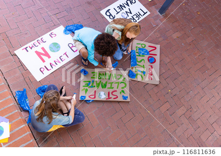 Happy diverse schoolchildren making ecology posters during outdoor school art class Happy diverse schoolchildren making ecology posters during outdoor school art class 116811636