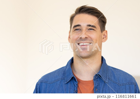 Smiling man in casual denim shirt looking away, feeling happy and relaxed Smiling man in casual denim shirt looking away, feeling happy and relaxed 116811661