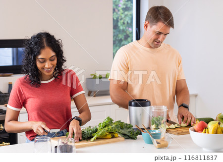 Preparing healthy meal, young couple chopping vegetables in modern kitchen Preparing healthy meal, young couple chopping vegetables in modern kitchen 116811837