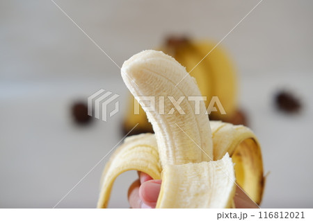 Banana on the hands of a girl. Selective focus. Banana on the hands of a girl. Selective focus. 116812021