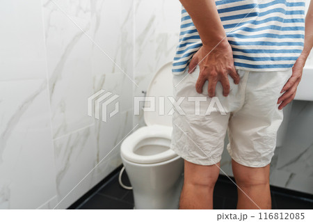 man suffers from diarrhea with toilet bowl in bathroom man suffers from diarrhea with toilet bowl in bathroom 116812085