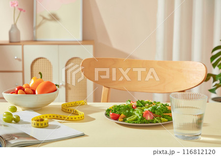 Photo template for weight losing products advertising in the room. A yellow countertop containing some weight losing stocks with vacant space for product presentation 116812120