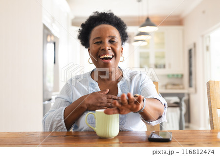 Portrait of happy senior african american woman having video call at home Portrait of happy senior african american woman having video call at home 116812474