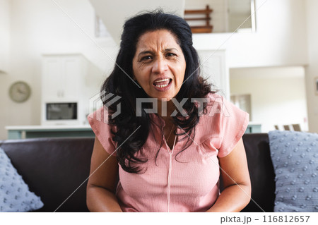 Senior biracial woman having video call, talking on couch in living room Senior biracial woman having video call, talking on couch in living room 116812657