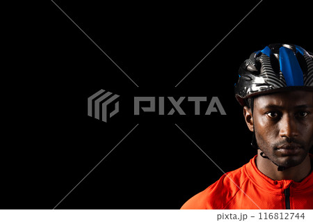 African American cyclist in gear, with copy space on a black background African American cyclist in gear, with copy space on a black background 116812744
