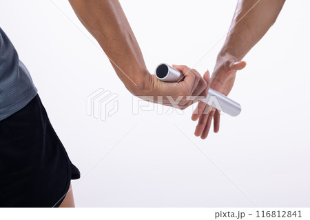 Close-up of a relay race with athletes passing the baton on a white background, with copy space Close-up of a relay race with athletes passing the baton on a white background, with copy space 116812841