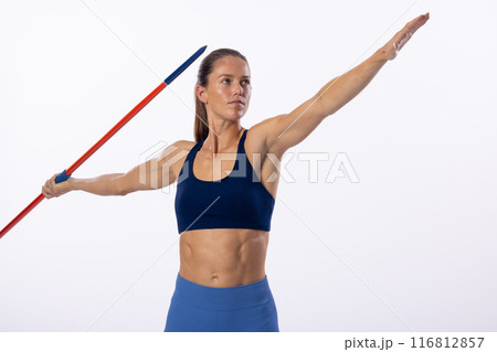 Young Caucasian female athlete prepares to throw a javelin on a white background Young Caucasian female athlete prepares to throw a javelin on a white background 116812857
