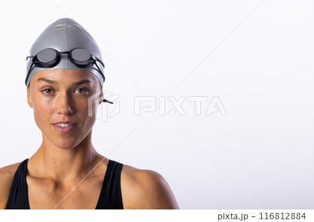 Caucasian female swimmer poses confidently on white background, space for text 116812884