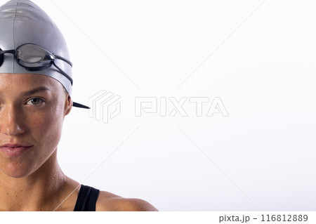 Young Caucasian female swimmer in swim gear, with copy space on a white background 116812889
