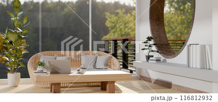 The interior design of a minimalist contemporary living room features a wicker sofa and decor. 116812932