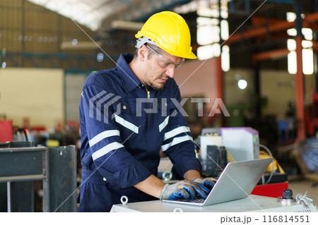 Senior professional electrical or industrial engineer inspecting and repairing a robotic system in the manufacturing factory close up. Robotic technician repairing - fixing a automated machine. Senior professional electrical or industrial engineer inspecting and repairing a robotic system in the manufacturing factory close up. Robotic technician repairing - fixing a automated machine. 116814551