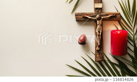 Crucifix with figure of Jesus, red candle and palm leaves on white background Crucifix with figure of Jesus, red candle and palm leaves on white background 116814826
