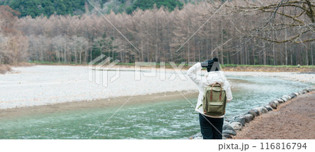 Woman tourist travel Kamikochi National Park, happy Traveler sightseeing Azusa river with mountain, Nagano Prefecture, Japan. Landmark for tourists attraction. Japan Travel, Destination and Vacation 116816794