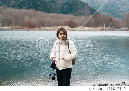 Woman tourist travel Kamikochi National Park, happy Traveler sightseeing Taisho pond with mountain, Nagano Prefecture, Japan. Landmark for tourists attraction. Japan Travel, Destination and Vacation Woman tourist travel Kamikochi National Park, happy Traveler sightseeing Taisho pond with mountain, Nagano Prefecture, Japan. Landmark for tourists attraction. Japan Travel, Destination and Vacation 116817143