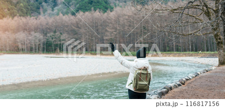Woman tourist travel Kamikochi National Park, happy Traveler sightseeing Azusa river with mountain, Nagano Prefecture, Japan. Landmark for tourists attraction. Japan Travel, Destination and Vacation 116817156