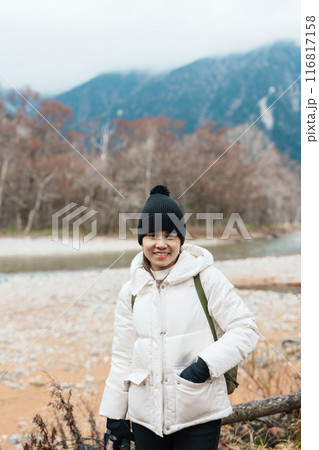 Woman tourist travel Kamikochi National Park, happy Traveler sightseeing Azusa river with mountain, Nagano Prefecture, Japan. Landmark for tourists attraction. Japan Travel, Destination and Vacation 116817158