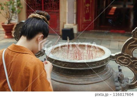 Woman Praying Outdoors In Temple Woman Praying Outdoors In Temple 116817604