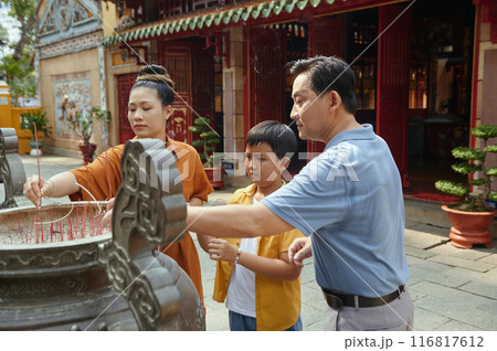Buddhist Family Praying With Aroma Sticks 116817612