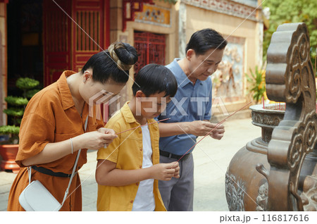 Family Using Aroma Sticks In Pray Family Using Aroma Sticks In Pray 116817616