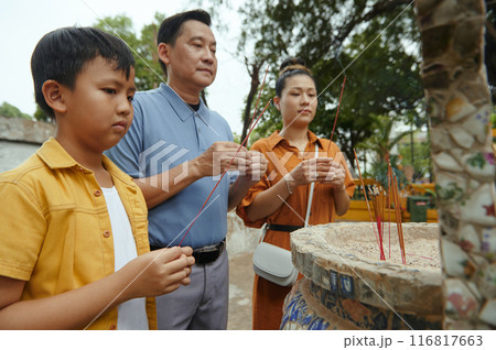 Family Using Aroma Sticks In Pray 116817663