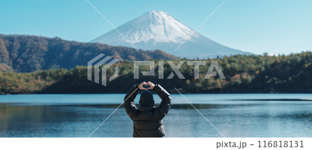 Woman tourist enjoy with Fuji Mountain at Lake Saiko, happy Traveler sightseeing Mount Fuji and road trip Fuji Five Lakes. Landmark for tourists attraction. Japan Travel, Destination and Vacation 116818131