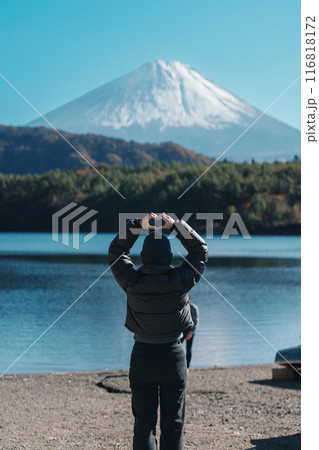 Woman tourist enjoy with Fuji Mountain at Lake Saiko, happy Traveler sightseeing Mount Fuji and road trip Fuji Five Lakes. Landmark for tourists attraction. Japan Travel, Destination and Vacation Woman tourist enjoy with Fuji Mountain at Lake Saiko, happy Traveler sightseeing Mount Fuji and road trip Fuji Five Lakes. Landmark for tourists attraction. Japan Travel, Destination and Vacation 116818172