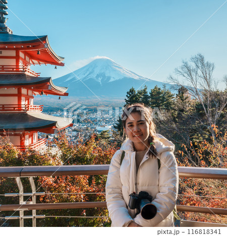 Woman tourist with mount Fuji at Chureito Pagoda in Autumn season, Traveler travel Arakurayama Sengen Park, Yamanashi, Japan. Landmark for tourist attraction. Japan Travel, Destination and Vacation 116818341