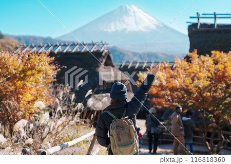 Woman tourist with mount Fuji at Saiko Iyashino Sato Nenba in Autumn season, happy Traveler travel Mt Fuji, Yamanashi, Japan. Landmark for tourist attraction. Japan Travel, Destination and Vacation 116818360