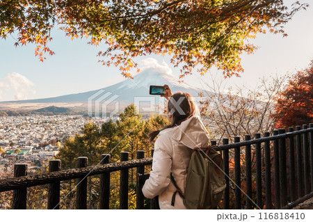 Woman tourist with mount Fuji at Chureito Pagoda in Autumn season, Traveler travel Arakurayama Sengen Park, Yamanashi, Japan. Landmark for tourist attraction. Japan Travel, Destination and Vacation Woman tourist with mount Fuji at Chureito Pagoda in Autumn season, Traveler travel Arakurayama Sengen Park, Yamanashi, Japan. Landmark for tourist attraction. Japan Travel, Destination and Vacation 116818410