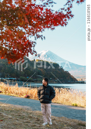 man tourist with Fuji Mountain at Lake Kawaguchi in Autumn season, happy Traveler travel Mount Fuji, Yamanashi, Japan. Landmark for tourists attraction. Japan Travel, Destination and Vacation man tourist with Fuji Mountain at Lake Kawaguchi in Autumn season, happy Traveler travel Mount Fuji, Yamanashi, Japan. Landmark for tourists attraction. Japan Travel, Destination and Vacation 116818565