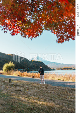 man tourist with Fuji Mountain at Lake Kawaguchi in Autumn season, happy Traveler travel Mount Fuji, Yamanashi, Japan. Landmark for tourists attraction. Japan Travel, Destination and Vacation man tourist with Fuji Mountain at Lake Kawaguchi in Autumn season, happy Traveler travel Mount Fuji, Yamanashi, Japan. Landmark for tourists attraction. Japan Travel, Destination and Vacation 116818567