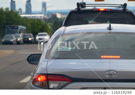 Calgary, Alberta, Canada. Jul 01, 2024. An Uber sign on a vehicle car on the road. 116819299