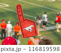 Calgary, Alberta, Canada. Jul 21, 2024. A fan holding a red foam finger with a Calgary Stampeders logo, cheering. 116819598
