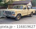 Calgary, Alberta, Canada. Jul 21, 2024. A sunny suburban scene with a yellow pickup truck A Ford F-Series Ranger model parked in the driveway of a neat two-story house. 116819627