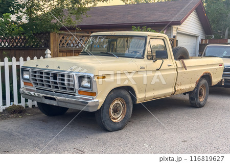 Calgary, Alberta, Canada. Jul 21, 2024. A sunny suburban scene with a yellow pickup truck A Ford F-Series Ranger model parked in the driveway of a neat two-story house. Calgary, Alberta, Canada. Jul 21, 2024. A sunny suburban scene with a yellow pickup truck A Ford F-Series Ranger model parked in the driveway of a neat two-story house. 116819627