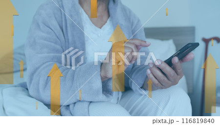 Image of up arrow over midsection of caucasian man sitting on bed and scrolling on cellphone 116819840