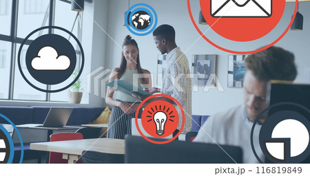 Image of icon in circles over diverse coworkers standing and discussing reports in office Image of icon in circles over diverse coworkers standing and discussing reports in office 116819849