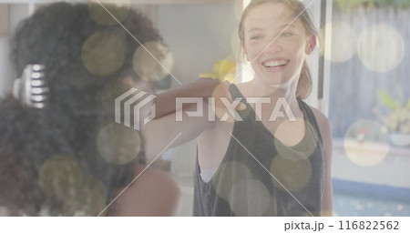 Image of light spots over happy diverse teenage girls practicing yoga together Image of light spots over happy diverse teenage girls practicing yoga together 116822562