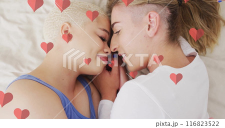 Image of hearts floating over diverse female couple embracing 116823522