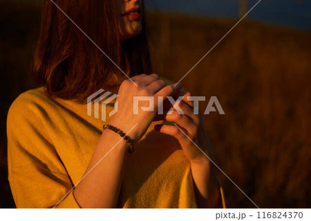 a portrait  young woman in mustard sweater in autumn mountains at sunset 116824370