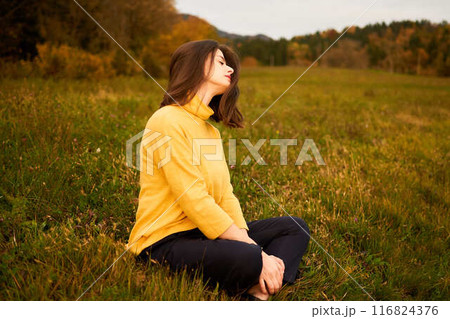 a portrait young woman in mustard sweater in autumn mountains at sunset a portrait young woman in mustard sweater in autumn mountains at sunset 116824376