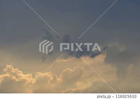 Evening cumulus clouds in the light of the sun. 116825610
